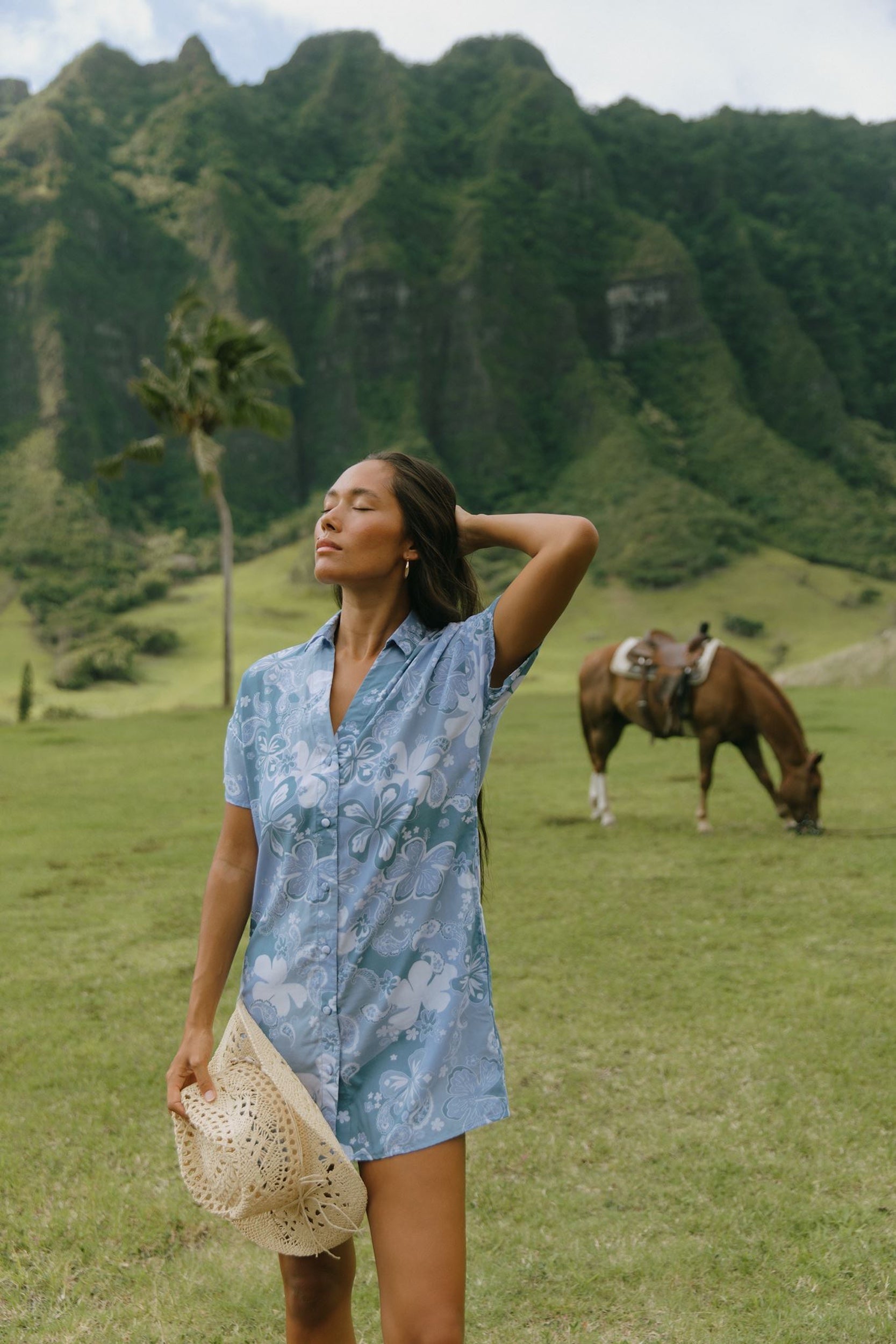 woman with brown hair wearing blue paniolo print collared button down dress