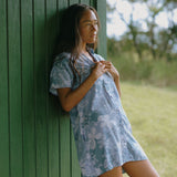 woman with brown hair wearing blue paniolo print collared button down dress