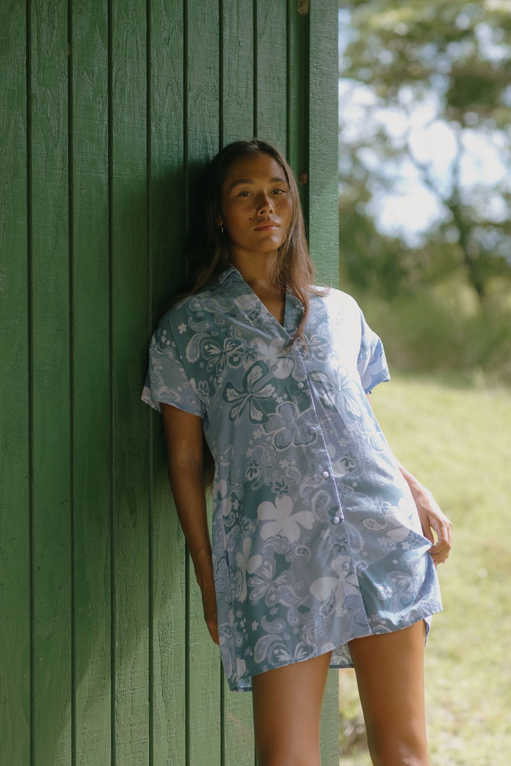 woman with brown hair wearing blue paniolo print collared button down dress