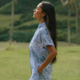 woman with brown hair wearing blue paniolo print collared button down dress