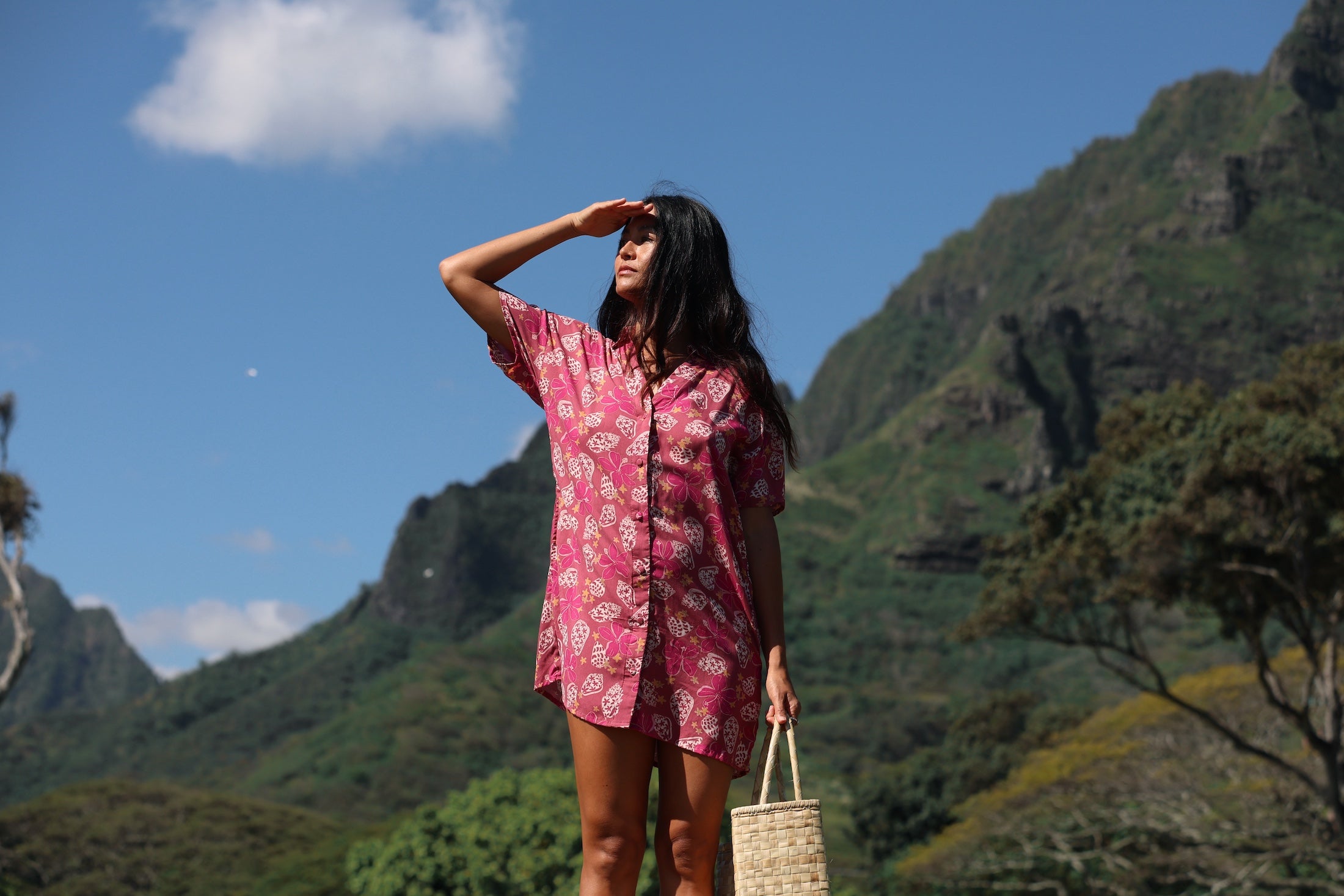 woman with brown hair wearing a collared button up dress with shells and pua print in pink color