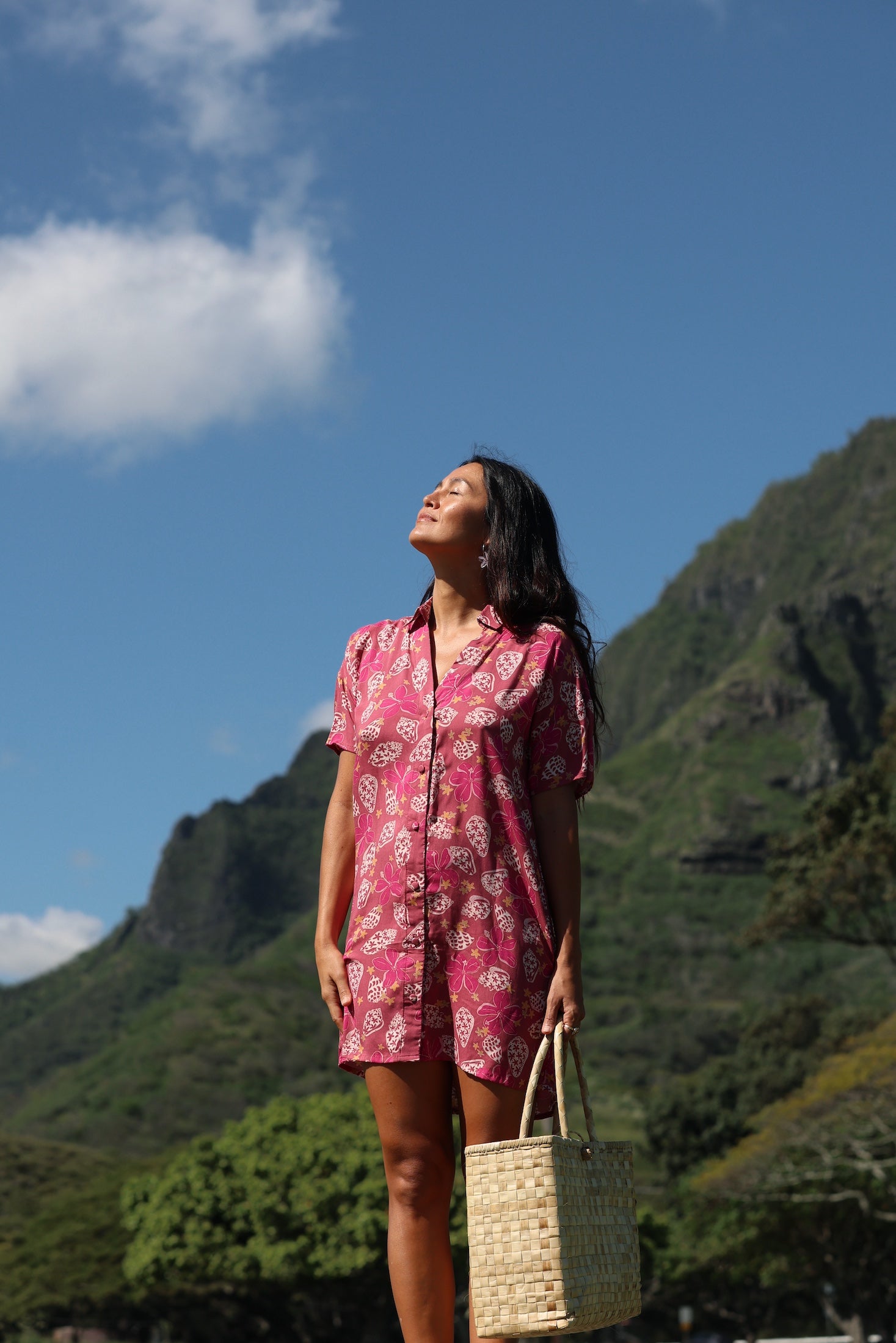 woman with brown hair wearing a collared button up dress with shells and pua print in pink color