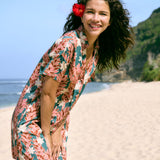 woman with brown hair wearing button up dress with red ginger and tiare print