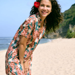 woman with brown hair wearing button up dress with red ginger and tiare print