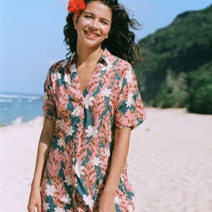 woman with brown hair wearing button up dress with red ginger and tiare print