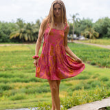 woman wearing a pink mini dress with lei print
