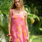 woman wearing a pink mini dress with lei print