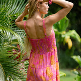 woman wearing a pink mini dress with lei print