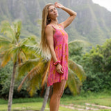 woman wearing a pink mini dress with lei print