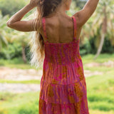 woman wearing a pink mini dress with lei print