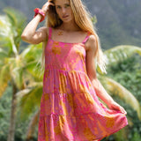 woman wearing a pink mini dress with lei print