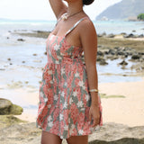 woman with brown hair wearing jade colored mini dress with smocked bodice with tiare ginger print