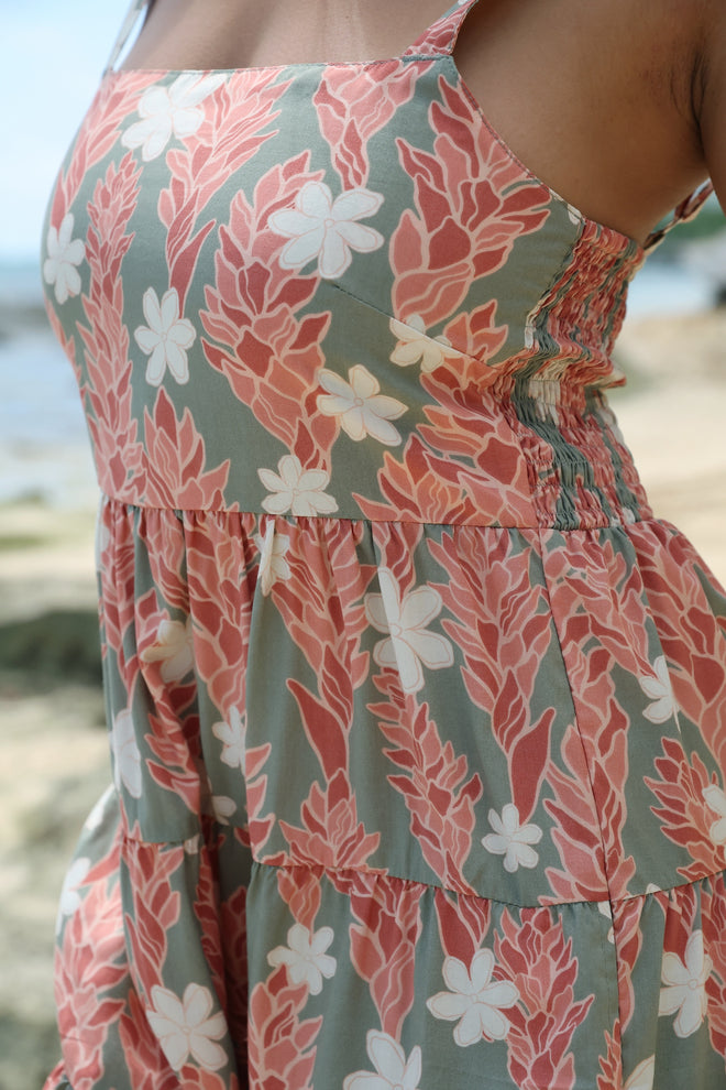 woman with brown hair wearing jade colored mini dress with smocked bodice with tiare ginger print