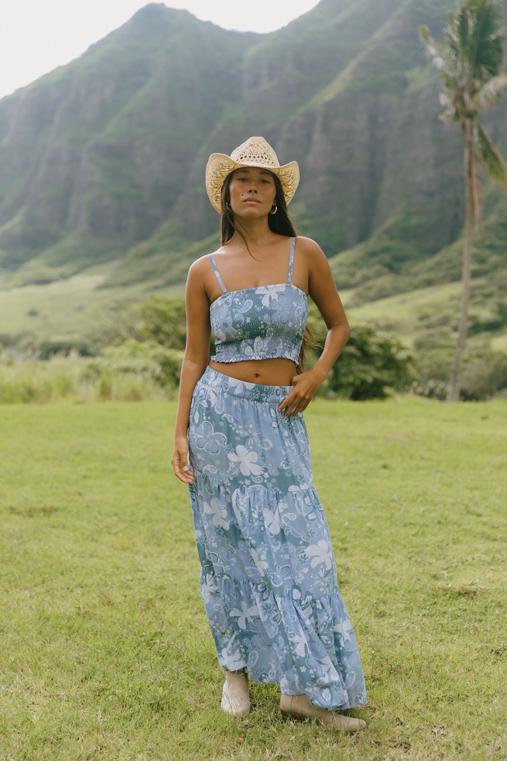 woman with brown hair wearing blue paniolo printed bandeau and maxi skirt set