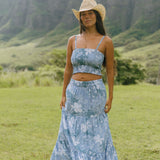 woman with brown hair wearing blue paniolo printed bandeau top with matching skirt