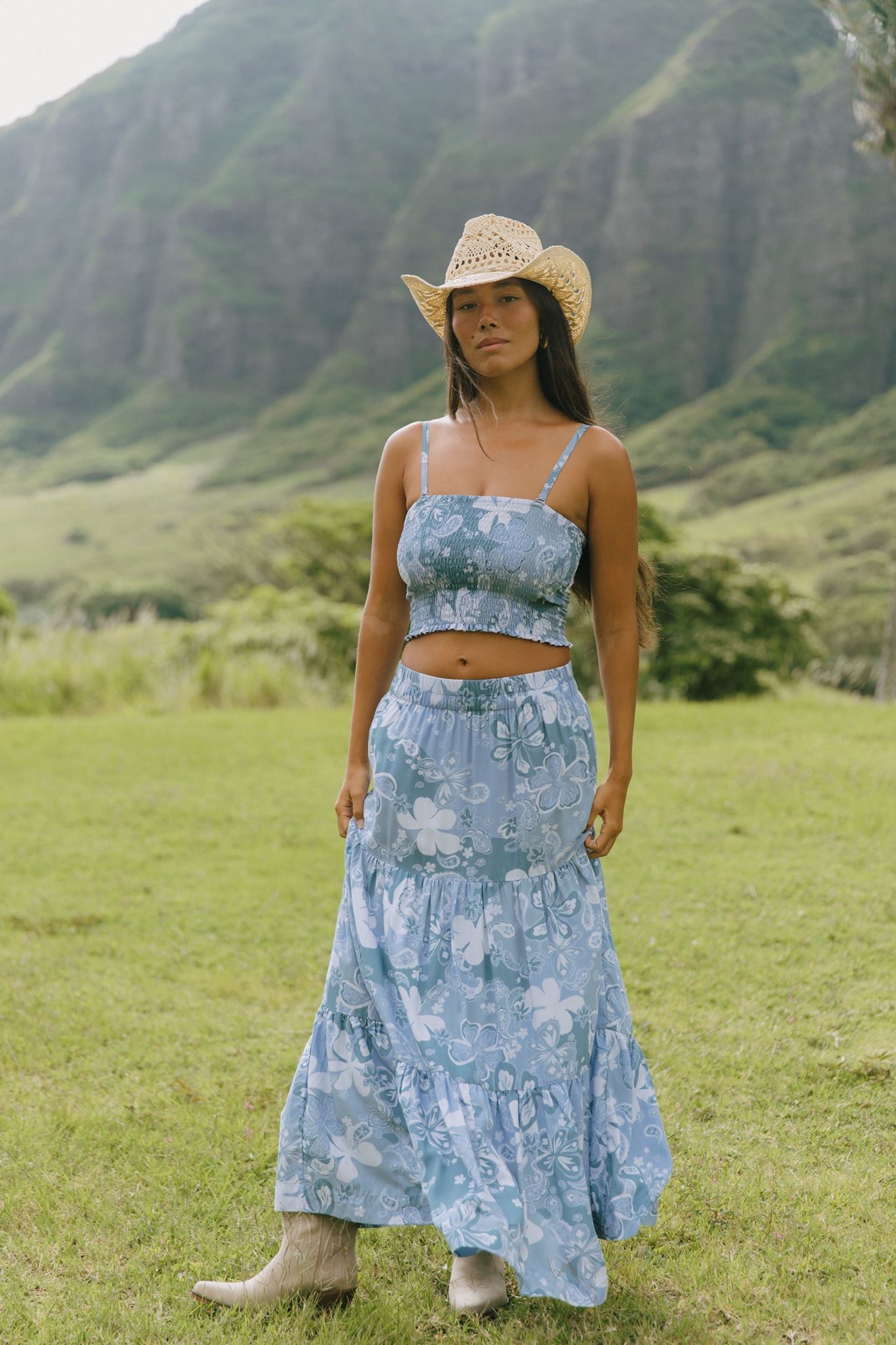 woman with brown hair wearing blue paniolo printed bandeau top with matching skirt