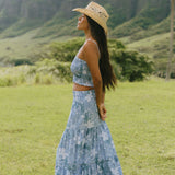 woman with brown hair wearing blue paniolo printed bandeau and maxi skirt set