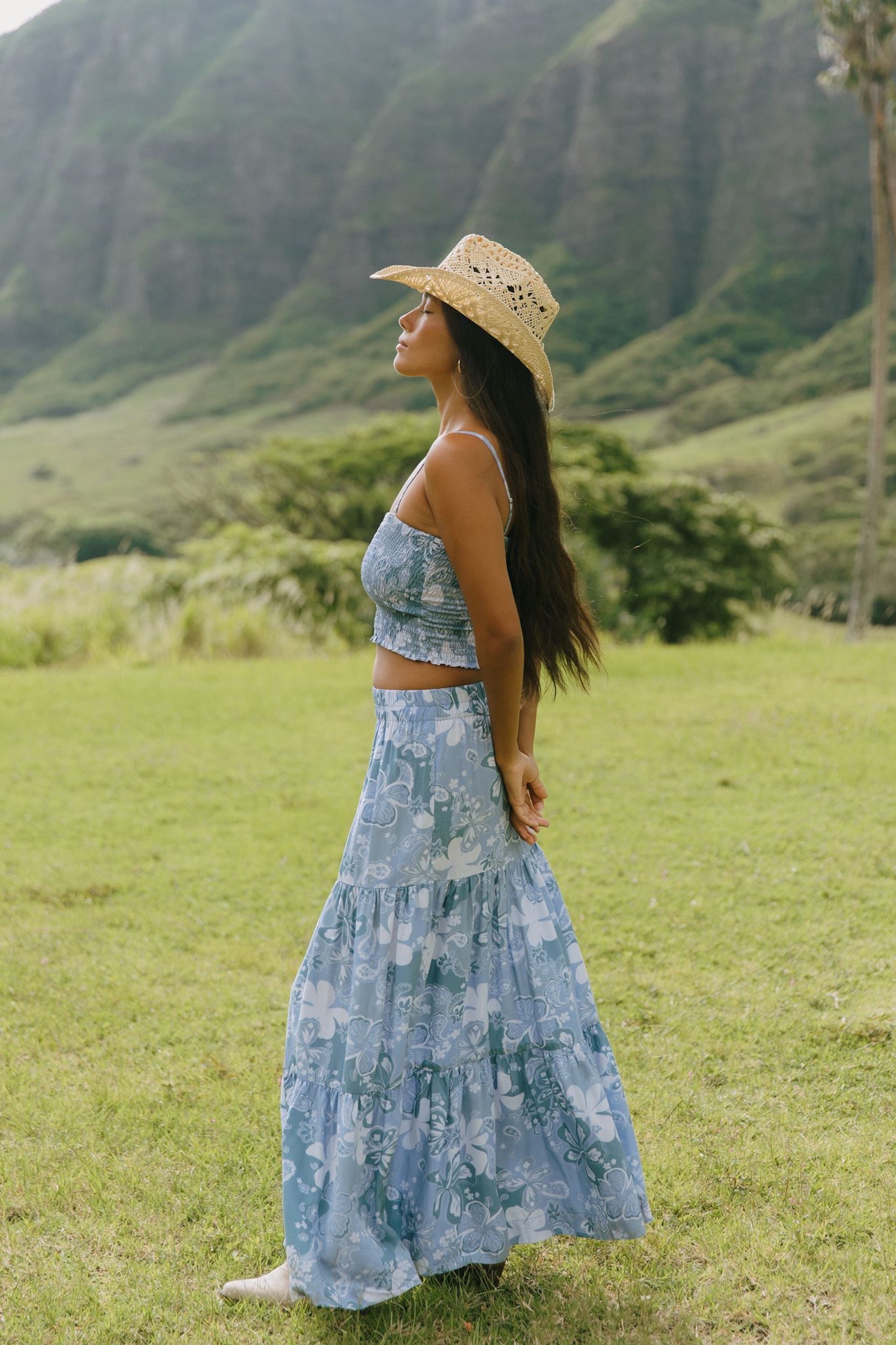 woman with brown hair wearing blue paniolo printed bandeau and maxi skirt set