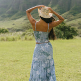 woman with brown hair wearing blue paniolo printed bandeau top with matching skirt