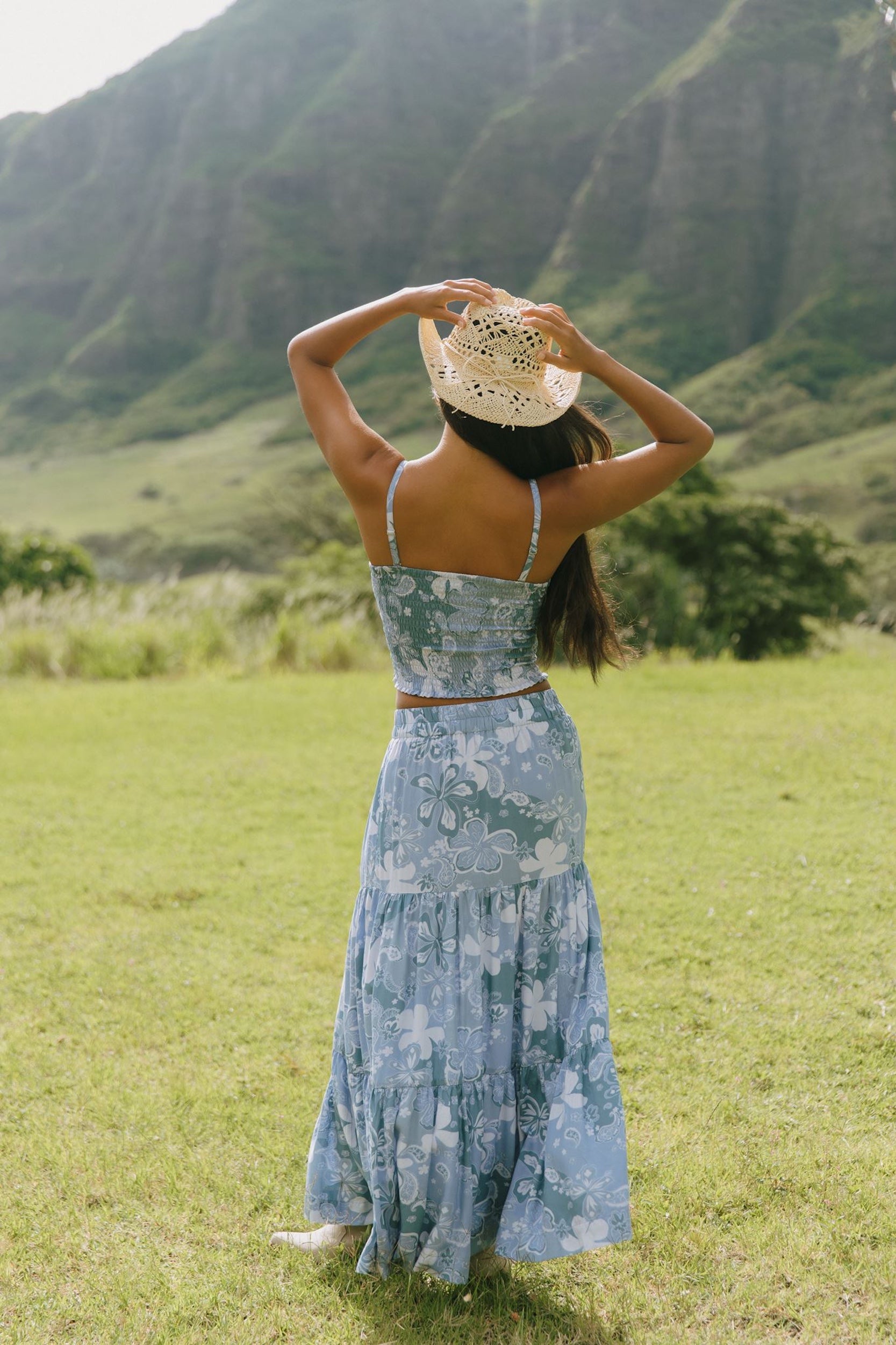 woman with brown hair wearing blue paniolo printed bandeau top with matching skirt