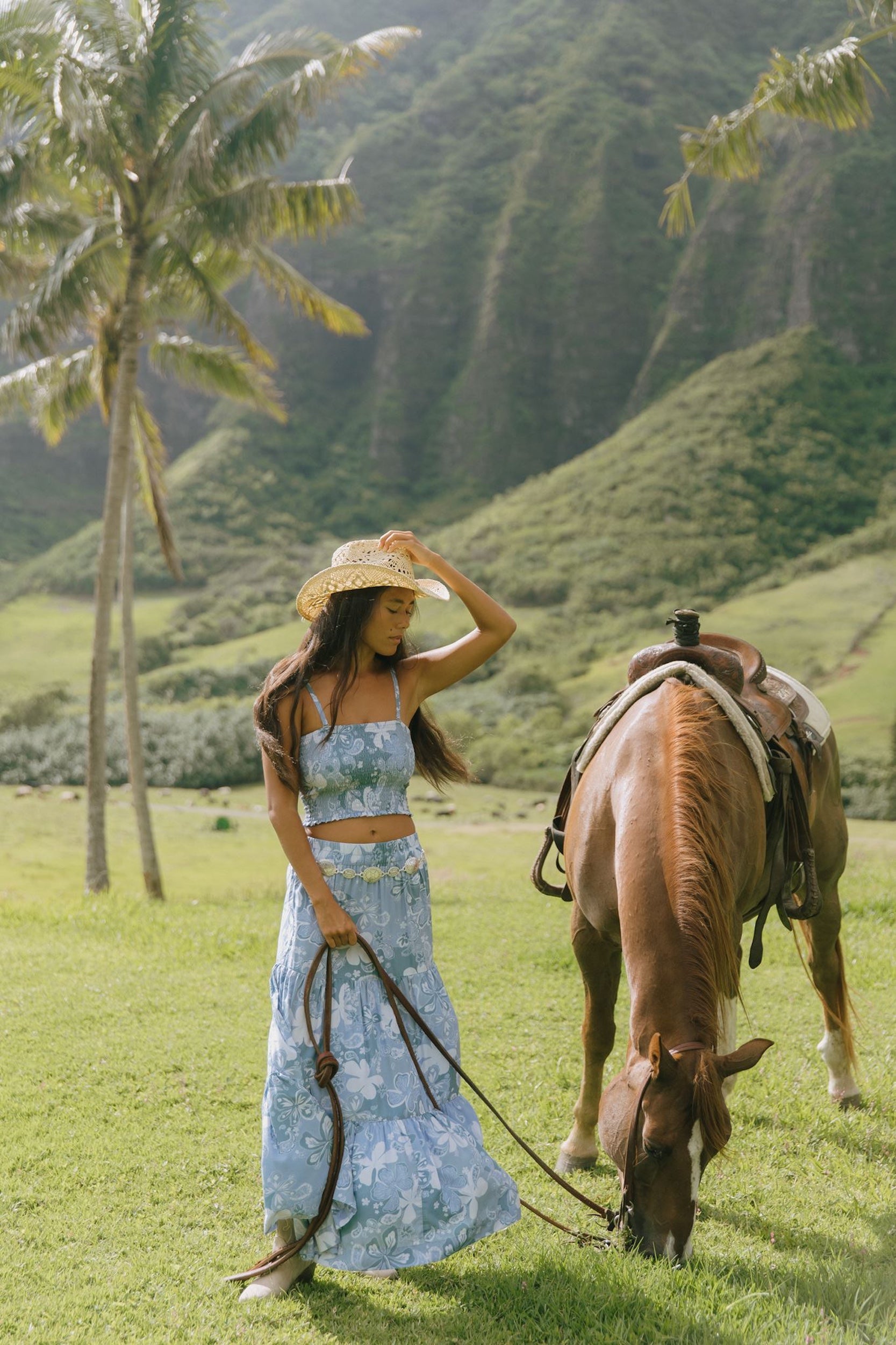 woman with brown hair wearing blue paniolo printed bandeau top with matching skirt