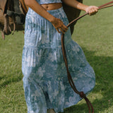woman with brown hair wearing blue paniolo printed bandeau and maxi skirt set