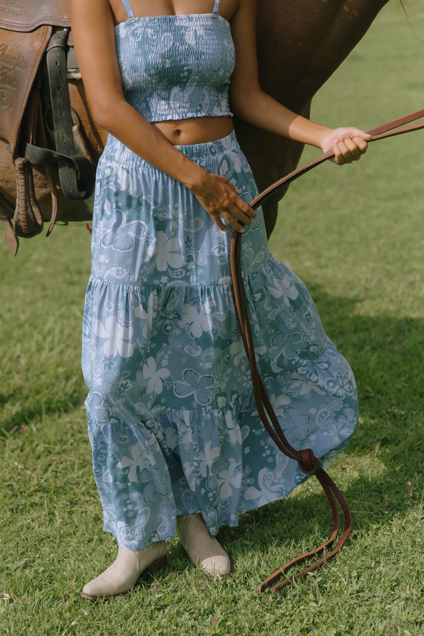 woman with brown hair wearing blue paniolo printed bandeau and maxi skirt set