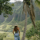woman with brown hair wearing blue paniolo printed bandeau and maxi skirt set