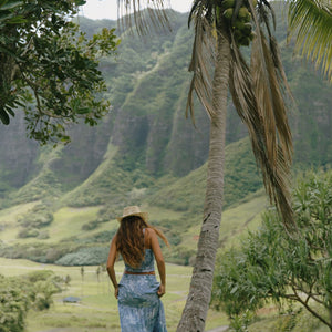 woman with brown hair wearing blue paniolo printed bandeau and maxi skirt set