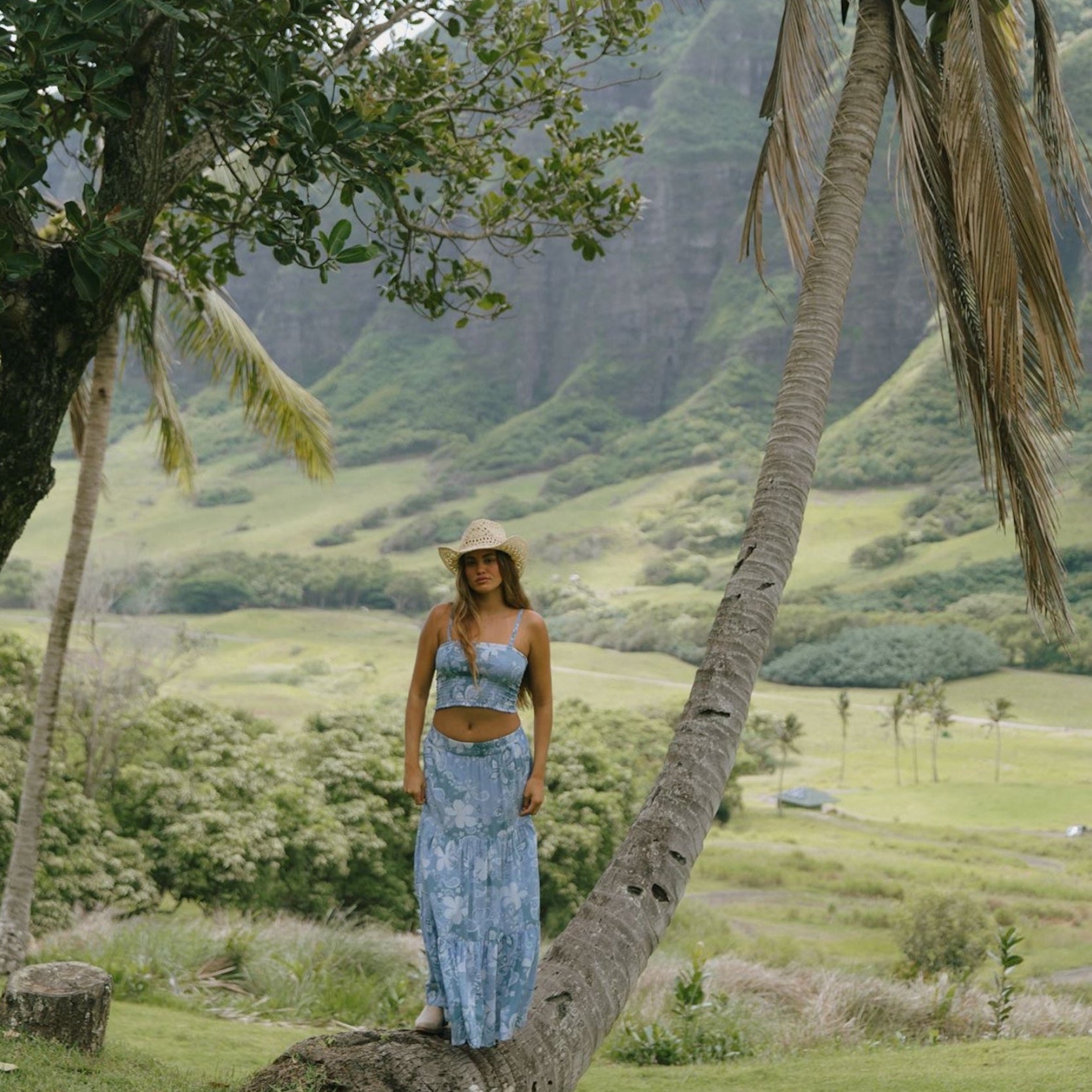 woman with brown hair wearing blue paniolo printed bandeau and maxi skirt set