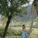 woman with brown hair wearing blue paniolo printed bandeau and maxi skirt set