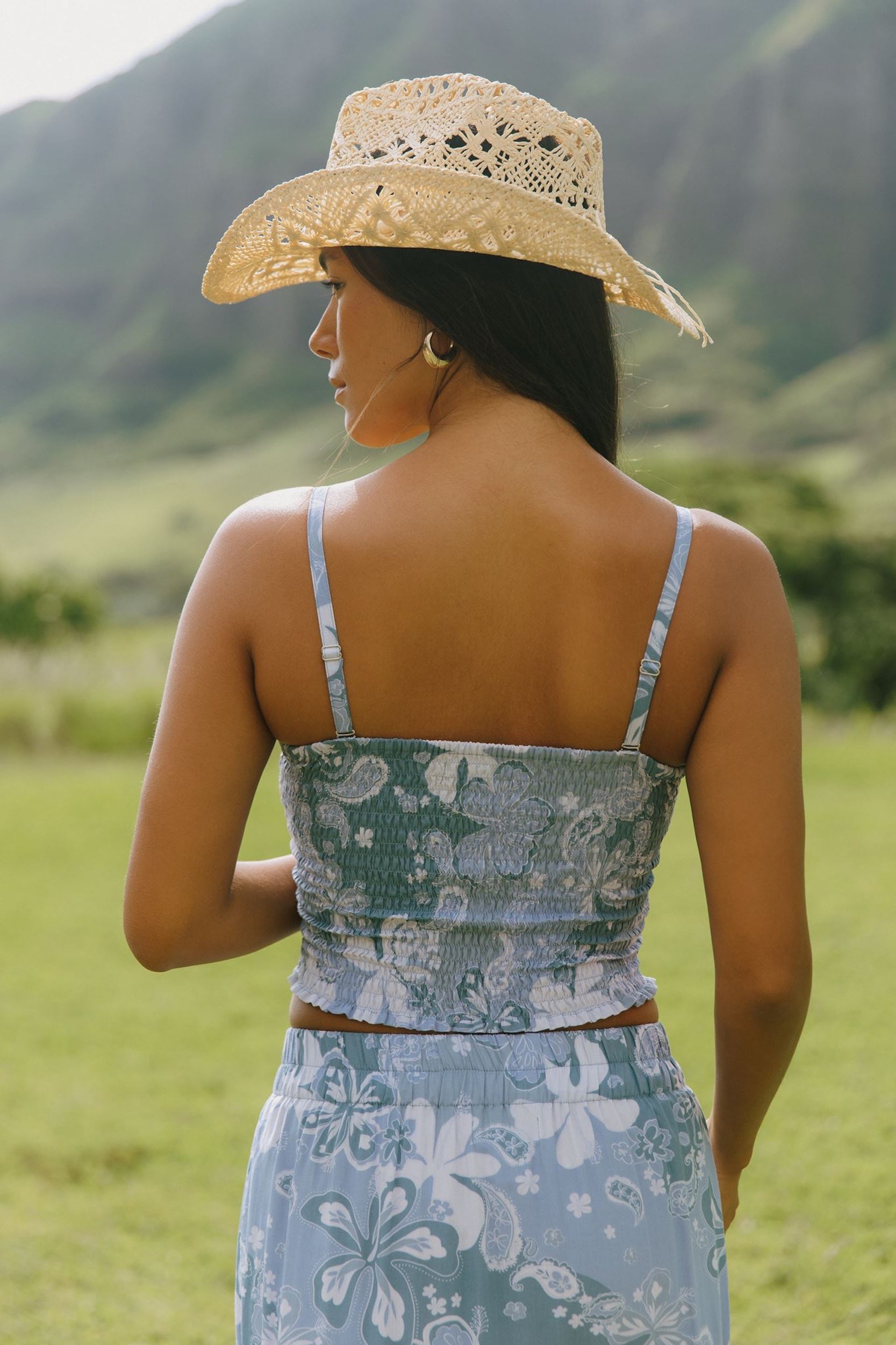 woman with brown hair wearing blue paniolo printed bandeau top with matching skirt