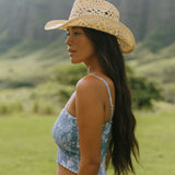 woman with brown hair wearing blue paniolo printed bandeau top with matching skirt