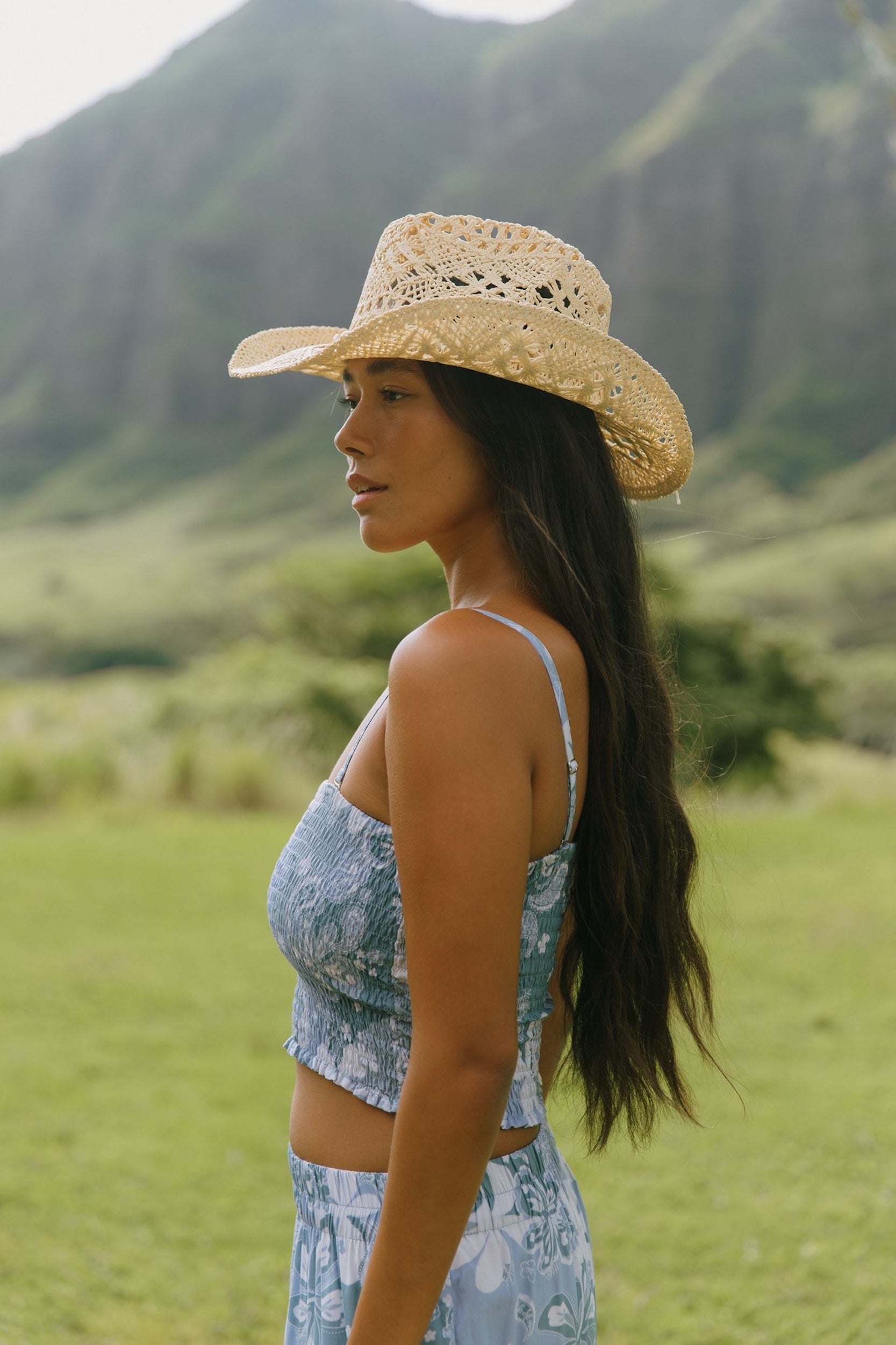 woman with brown hair wearing blue paniolo printed bandeau top with matching skirt