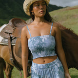 woman with brown hair wearing blue paniolo printed bandeau top with matching skirt