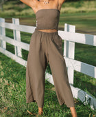 Woman wearing smocked tube top and loose pant in medium brown linen.