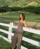 Woman wearing smocked tube top and loose pant in medium brown linen.