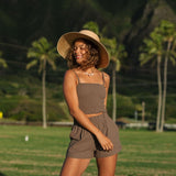 Woman wearing smocked tube top with spaghetti straps and short in medium brown linen.