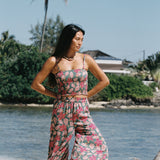 woman with brown hair wearing a teal bandeau top with removable straps with shell and pua print