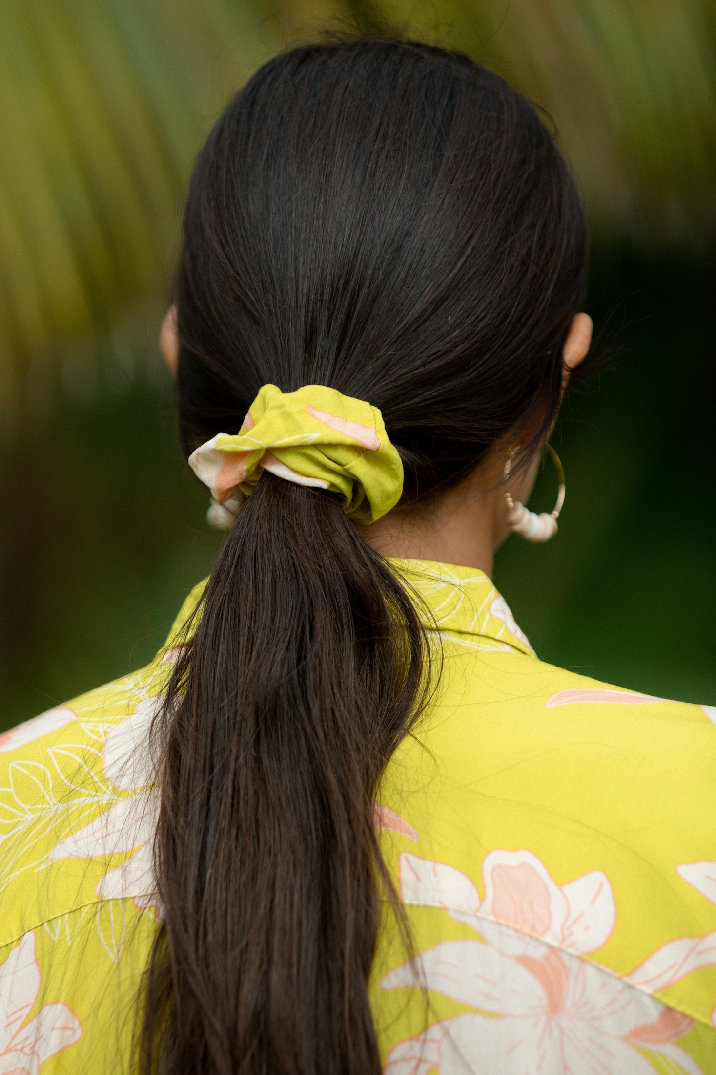 woman wearing scrunchie in bright orchid pattern