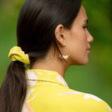 woman wearing scrunchie in bright orchid pattern