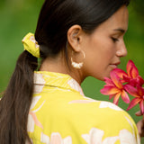 woman wearing scrunchie in bright orchid pattern