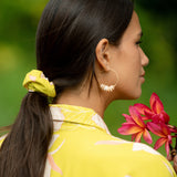woman wearing scrunchie in bright orchid pattern