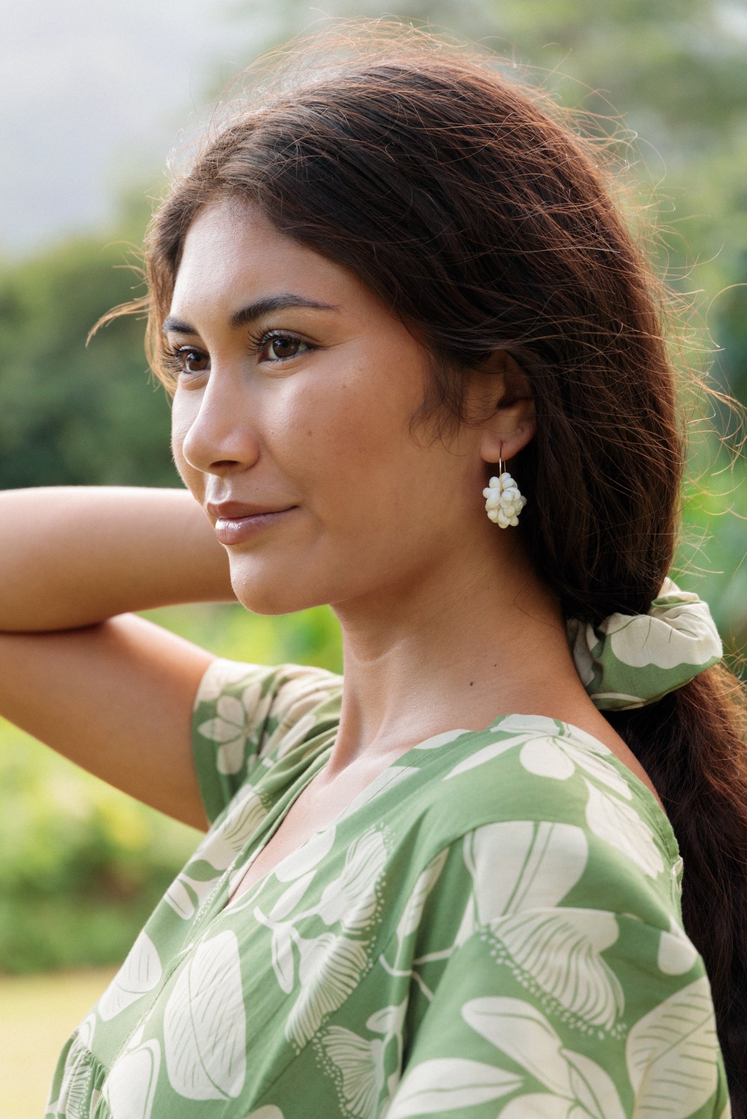 girl with brown hair wearing green scrunchie with native Hawaii plant pattern