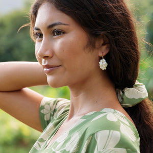 girl with brown hair wearing green scrunchie with native Hawaii plant pattern