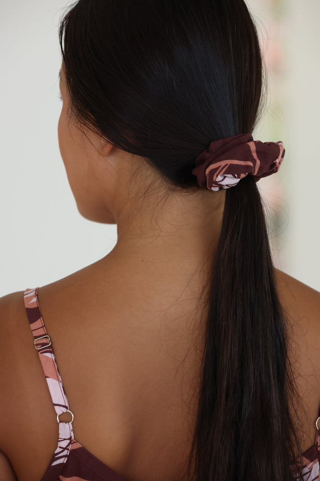 woman wearing brown scrunchie with protea pattern