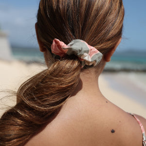 woman with brown hair wearing jade colored scrunchie with tiare ginger print