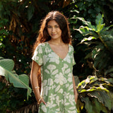 woman wearing green romper with native Hawaiian plants