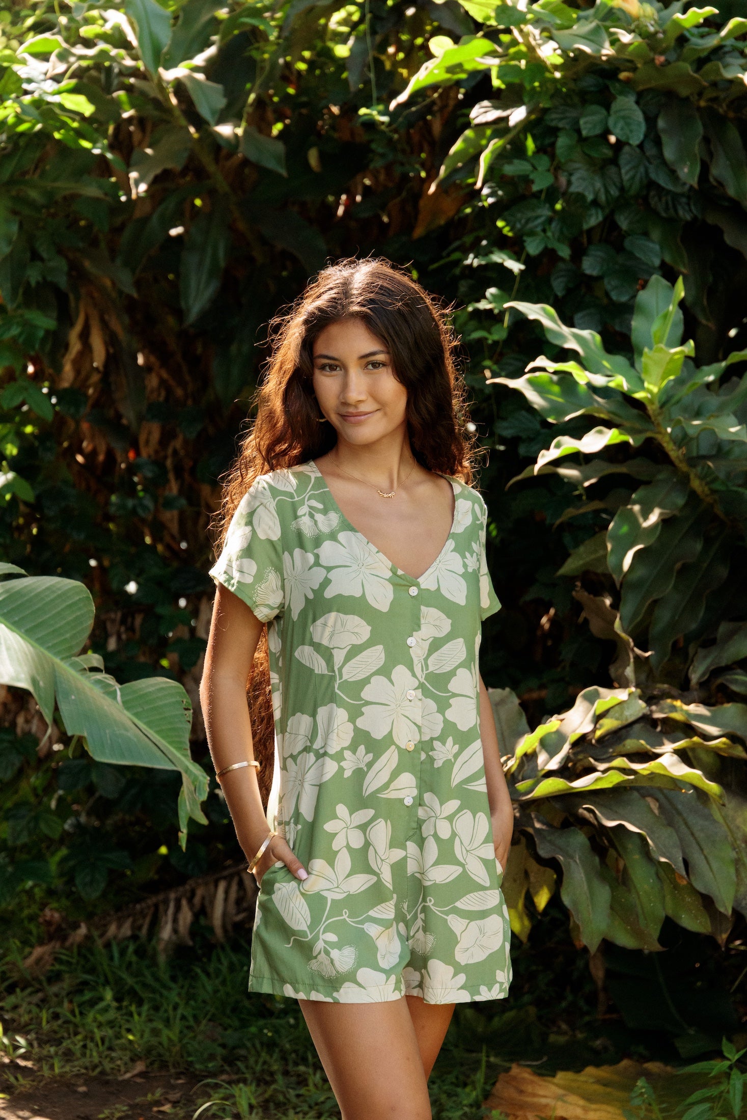 woman wearing green romper with native Hawaiian plants