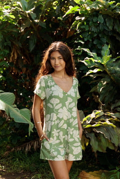 woman wearing green romper with native Hawaiian plants